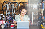 Smiling woman working in bicycle shop