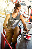 Man with headphones at laptop in cafe