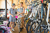 Couple eyeing bicycle in bicycle shop