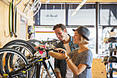 Couple looking at price tags on bicycles