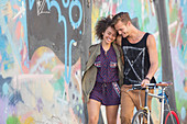 Couple hugging and walking with bicycle