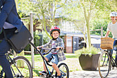 Boy in helmet riding with father