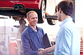 Mechanic and customer handshaking