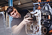 Mechanic fixing part in auto repair shop