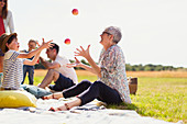 Grandmother and grandson juggling apples