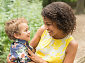 Smiling mother and son face to face