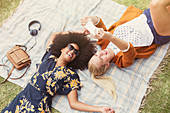 Friends taking selfie relaxing in grass