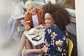 Woman with friend at sidewalk cafe