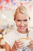 Blonde woman drinking cappuccino