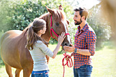 Couple petting horse