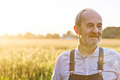 Senior farmer in wheat field