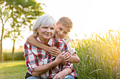 Smiling grandmother and grandson hugging