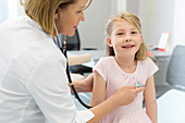 Pediatrician using stethoscope