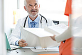 Doctor and nurse reviewing medical record