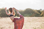Boho woman in king dancer yoga pose