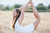 Boho woman in king dancer yoga pose