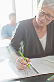 Senior woman doing homework