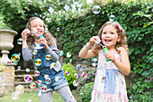 Carefree girls blowing bubbles