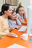 Mother and daughters using computer