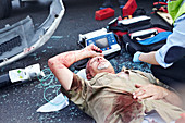 Car accident victim laying in road