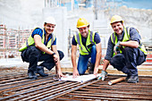 Construction workers reviewing blueprint