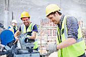 Construction workers using equipment