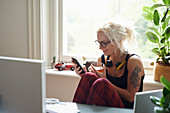 Young woman texting in home office