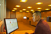 Engineer working at computer control room