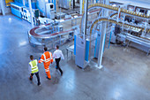 Workers and supervisor walking in factory