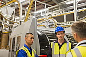 Workers talking in printing plant