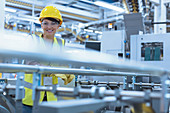 Portrait female worker at machinery