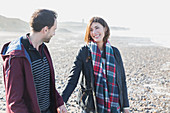 Smiling couple walking on beach