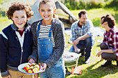 Brother and sister with vegetable skewers