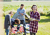 Family barbecuing at sunny campsite