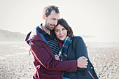 Couple hugging on sunny beach