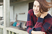 Portrait smiling brunette woman on porch