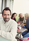 Man in sweater with family in background