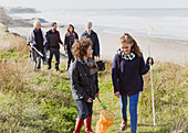 Family with nets on grass beach path