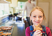 Girl eating gingerbread cookie