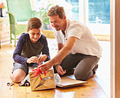 Father and son making robot costume