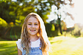 Portrait smiling girl in sunny garden