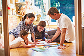 Family drawing and colouring on floor