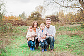 Portrait smiling family in rural park