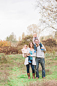 Portrait smiling family in autumn park