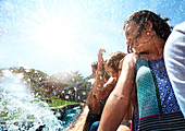 Women getting splashed on water park ride