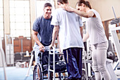 Physiotherapists helping man with walker