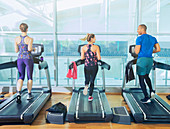 Man and women running on treadmills