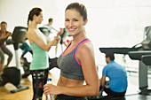 Portrait smiling woman resting at gym
