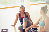 Smiling women talking in gym studio
