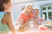 Senior couple smiling and drinking wine
